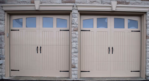 Professional garage door repair technician working on broken springs, cables, and rollers in Cincinnati, OH showing expert repair service