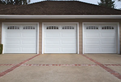 Professional garage door technician performing comprehensive tune-up maintenance service including lubrication, hardware inspection, balance testing, and safety system calibration to prevent breakdowns and extend garage door lifespan for Cincinnati homeowners