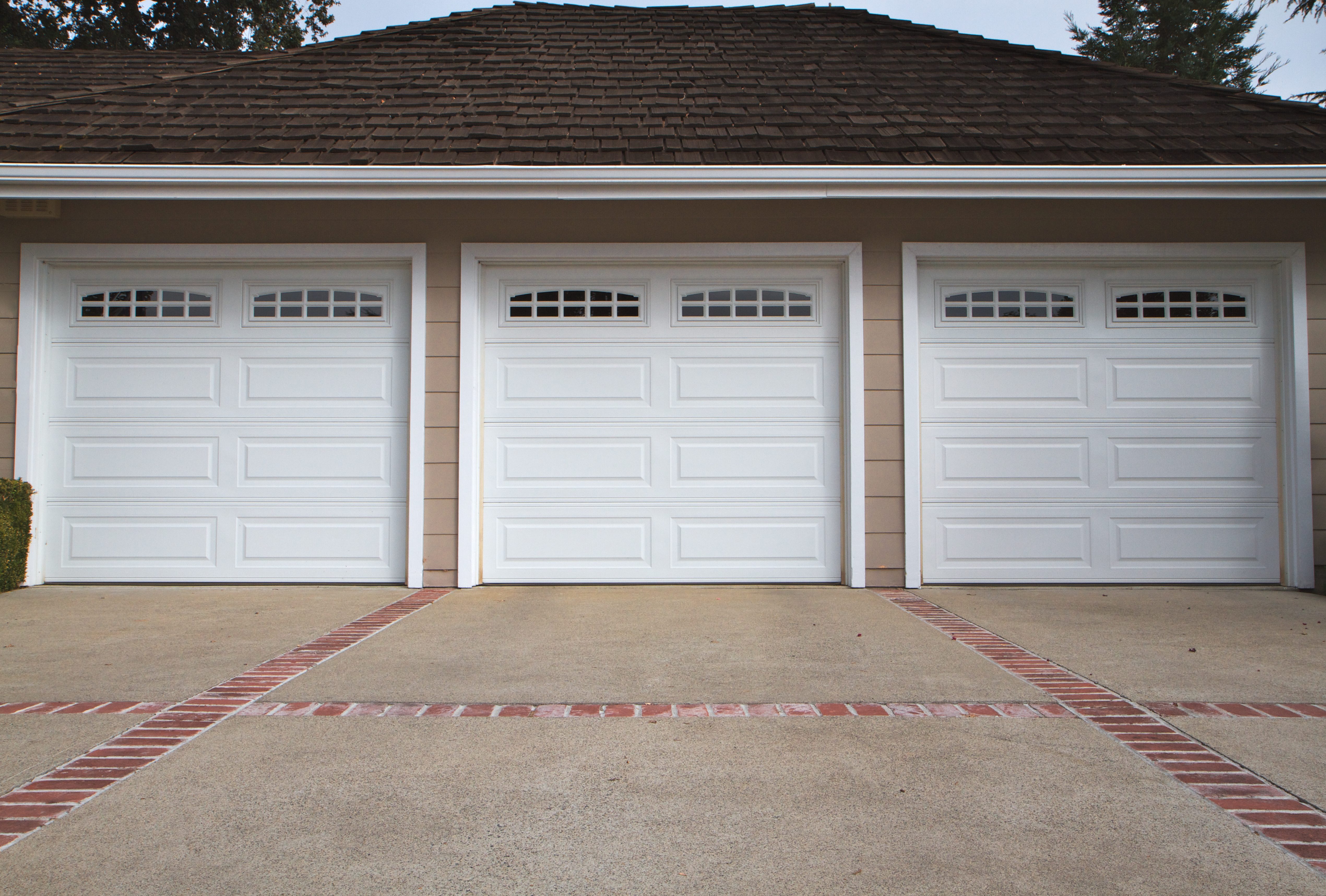 Routine garage door maintenance with lubrication and safety checks
