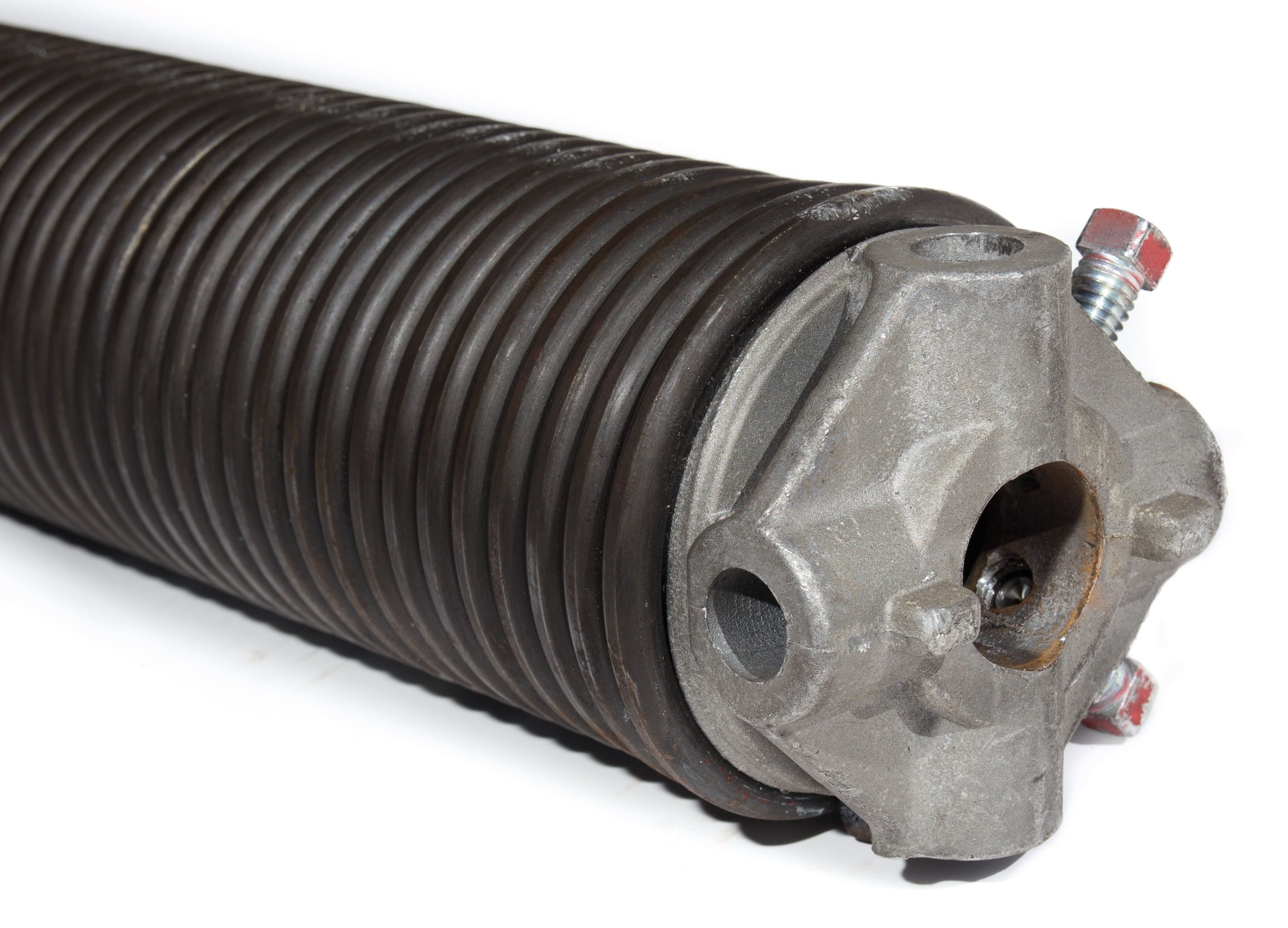 Technician replacing a broken garage door spring