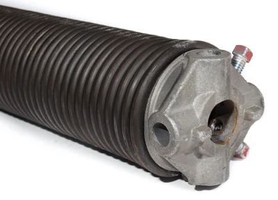 Professional garage door technician installing new high-tension torsion spring system above residential garage door showing expert spring replacement service with proper safety equipment and tools for Cincinnati homeowners